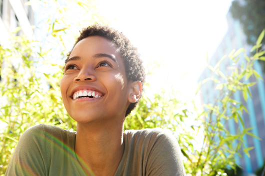 A smiling person outside.