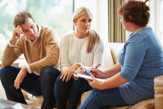 A social worker consults with a couple.