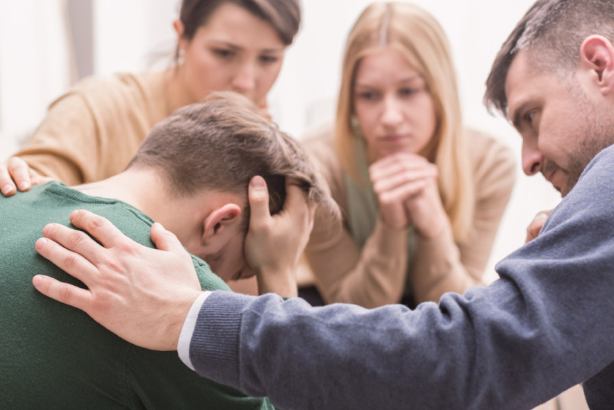 A group supporting a distressed person.