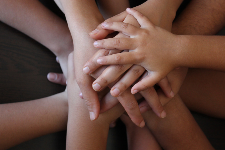 A group of hands together.